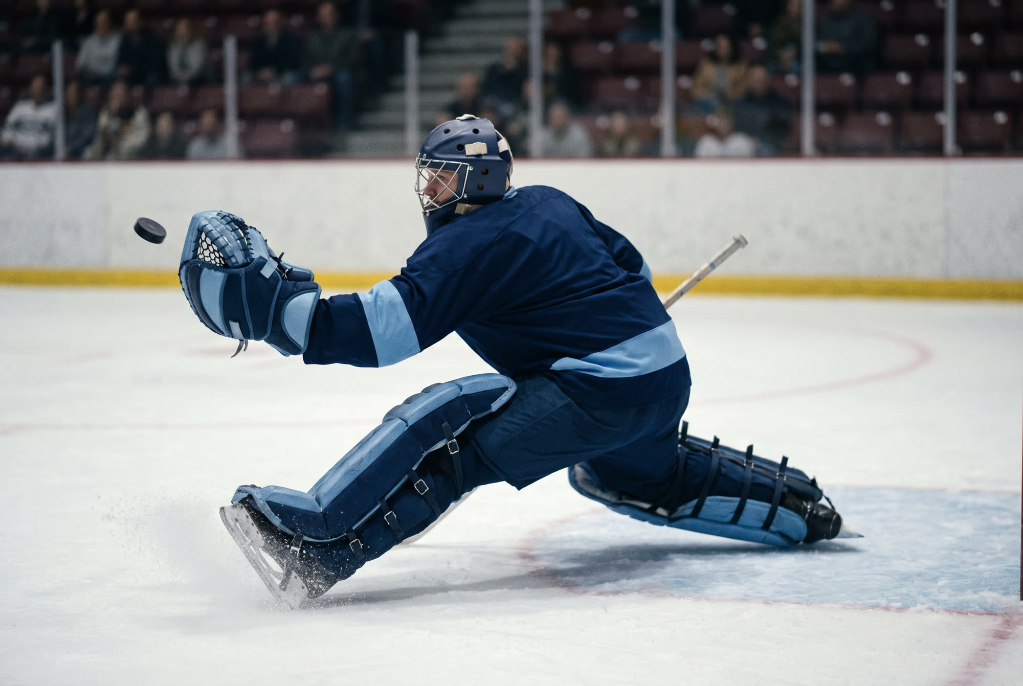 A goaltender making a dramatic glove save