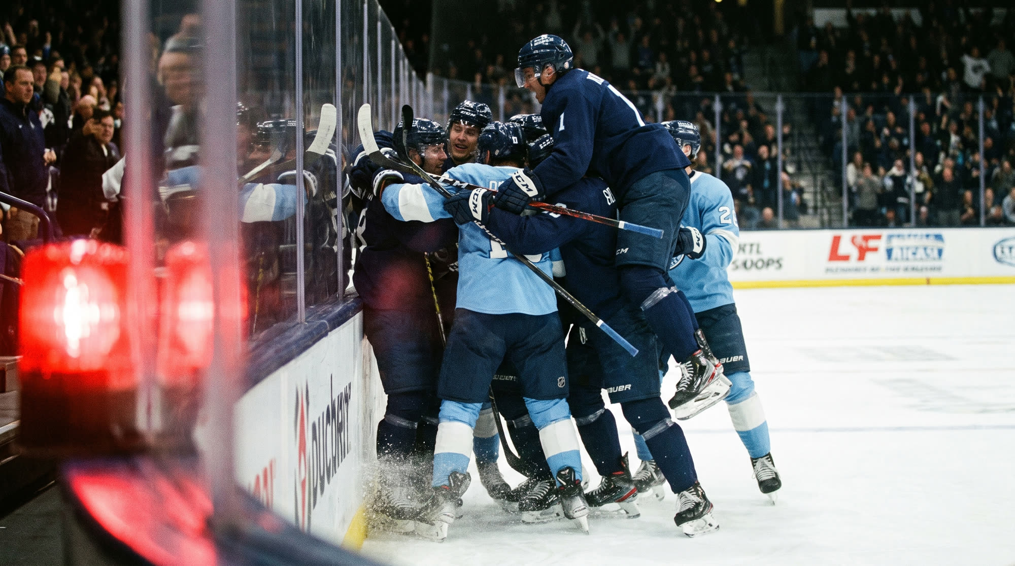 Admirals players mobbing a teammate after a goal