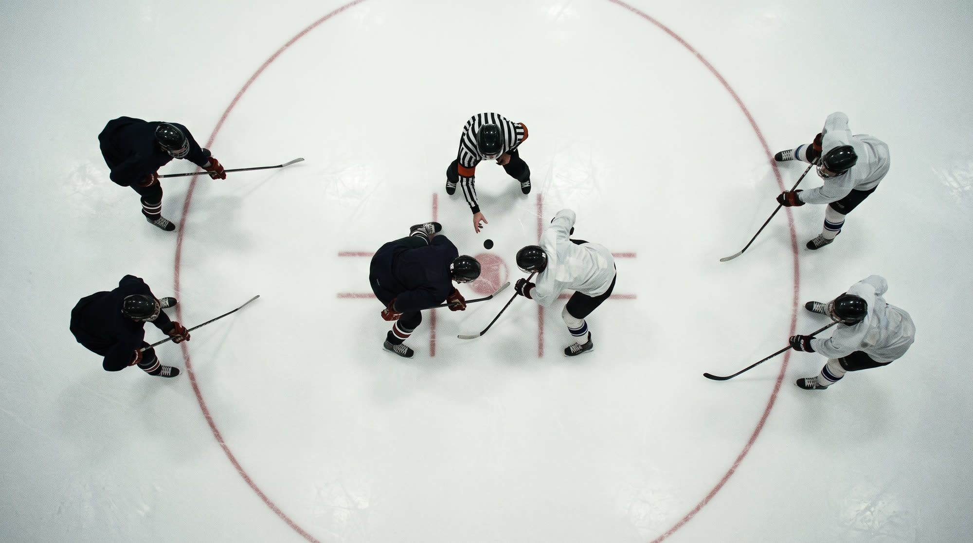 Overhead view of a center-ice faceoff