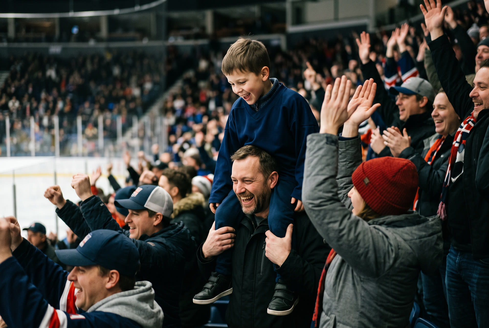 A dad with his kid on his shoulders as the crowd celebrates an Admirals goal